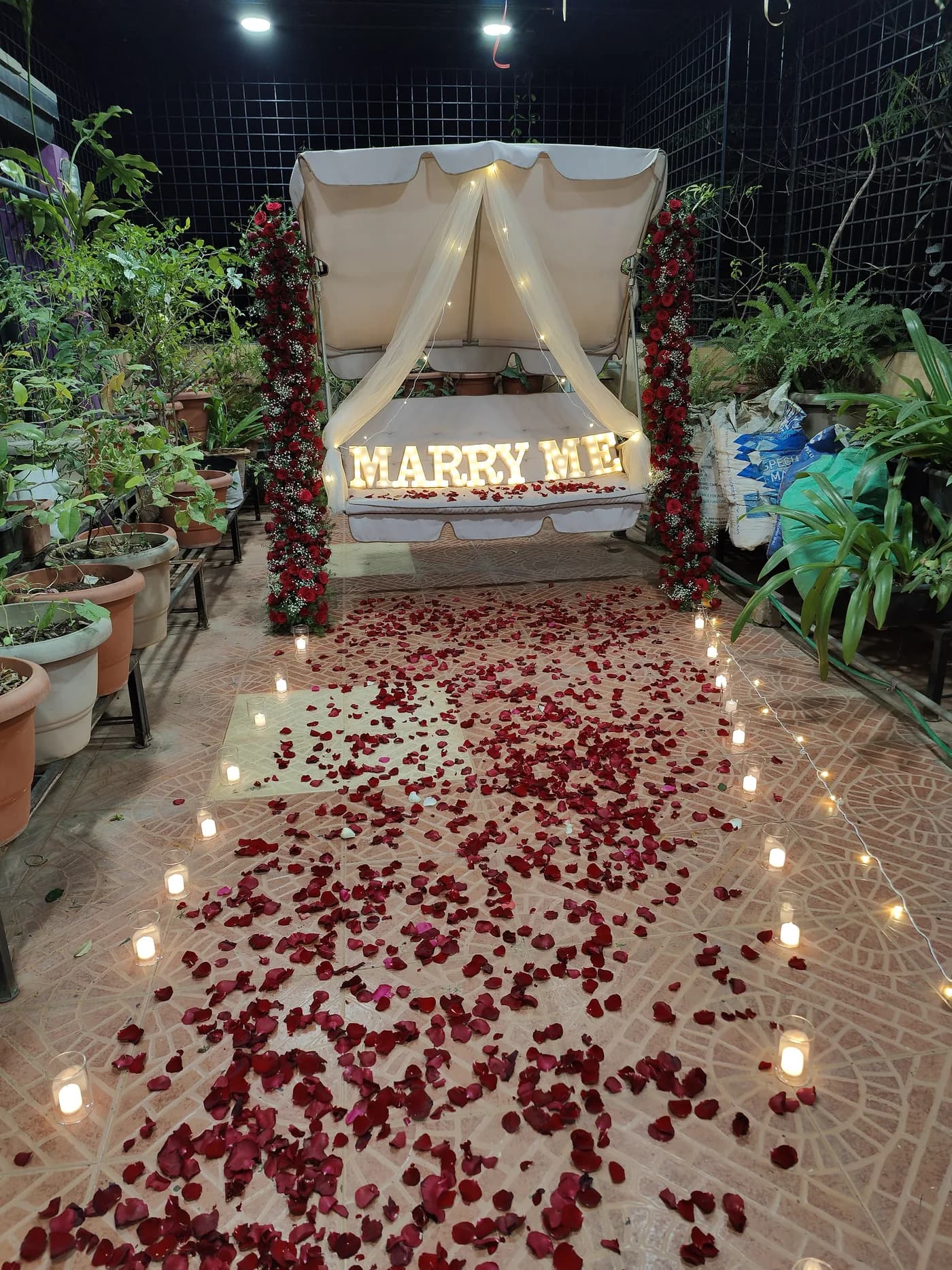 Romantic outdoor proposal décor with lights and flowers in Bangalore